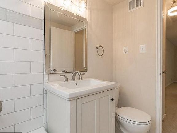 Bathroom in tub facing the door