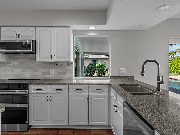 Enjoy views of lanai & pool deck from the kitchen.