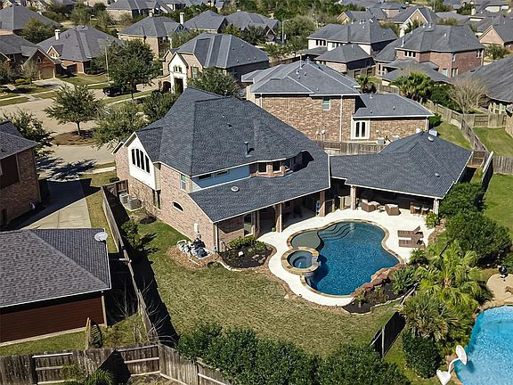 Wow - what a backyard! Outdoor living, kitchen, pool, hot tub AND plenty of yard leftover!