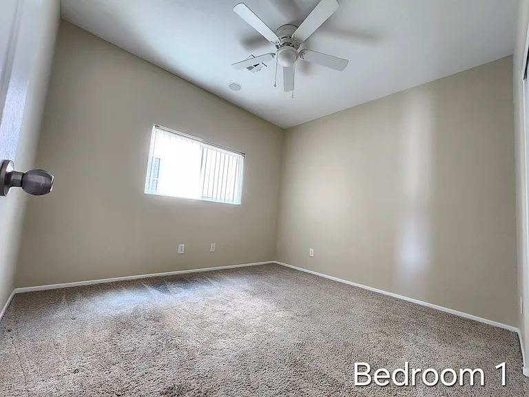 Bedroom 1 with ceiling fan and light