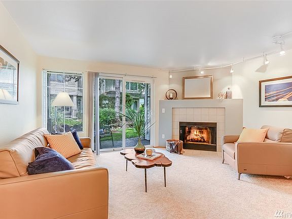 Enjoy abundant natural light from this large slider and window looking out to a covered patio and greenspace beyond. 