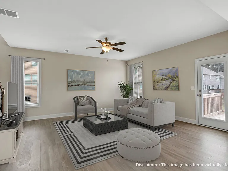 Living room filled with abundant natural light from expansive windows.