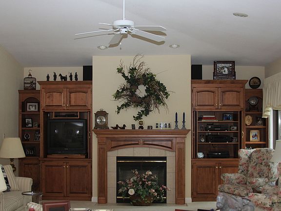 Living room with built in shelves and gas fireplace