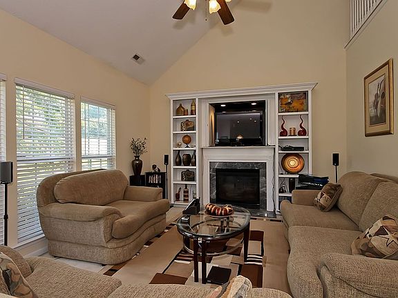 Great Room with Built-ins, Vaulted Ceiling, Fireplace and Lighted Ceiling Fan