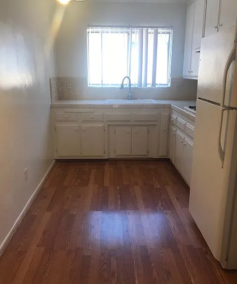 bright kitchen with lots of cabinets and space for breakfast table