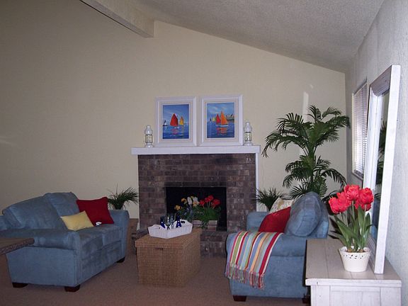 Vaulted ceilings and wood burning fireplace in the living area.