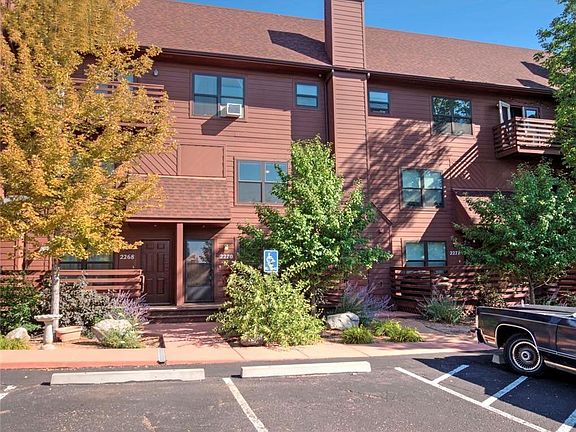 View of dedicated parking spot (left of handicap spot) and front door