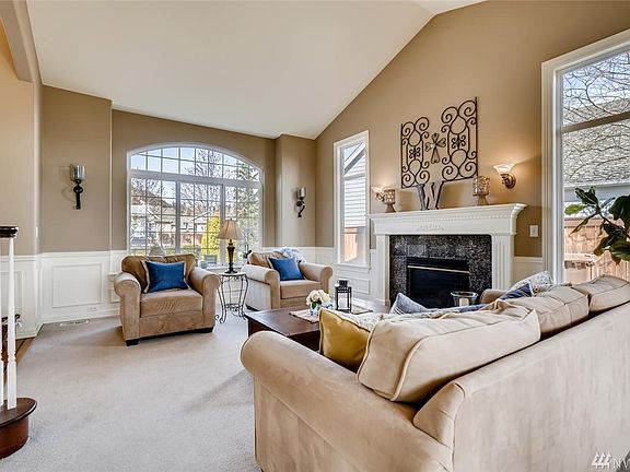 Soaring ceiling, large windows and a craftsman fireplace