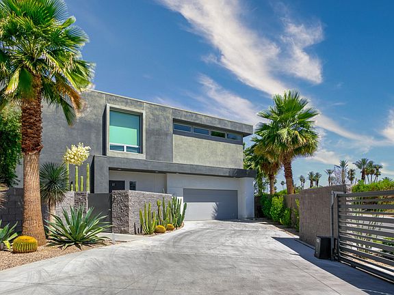 Front of house with garage that fits two cars.