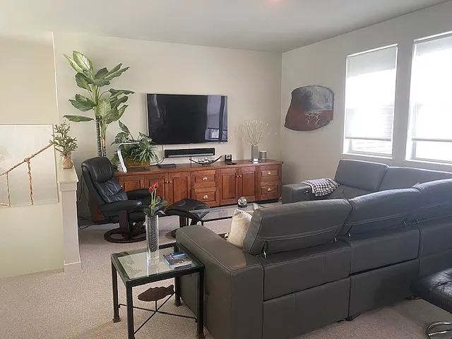 Media space upstairs with glass desk and leather office chair