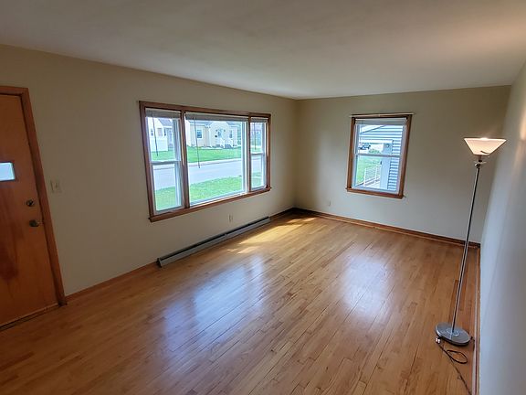 Family room. Entry door is to the left. Hardwood floors.