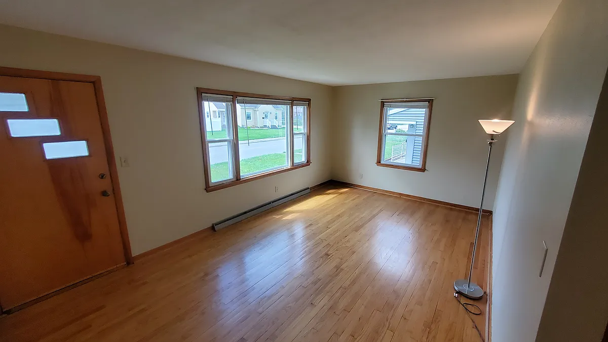 Family room. Entry door is to the left. Hardwood floors. - 2116 Central Ave