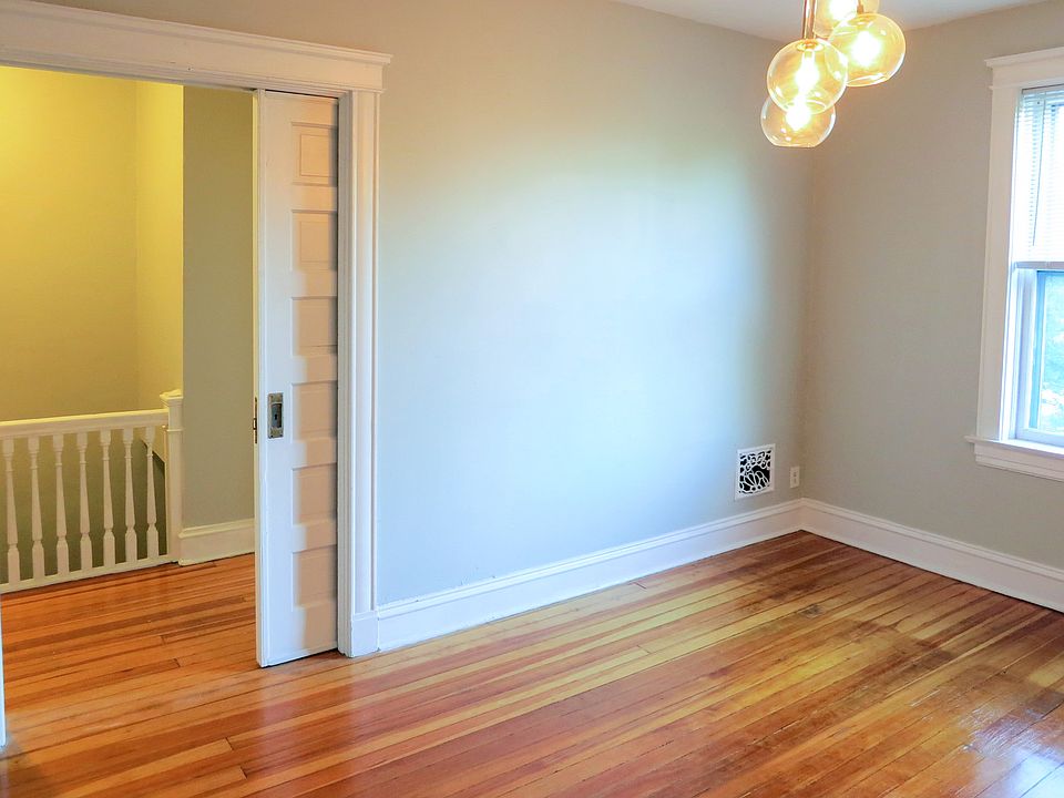 Bedroom closed off by original pocket door, space for King bed and furniture