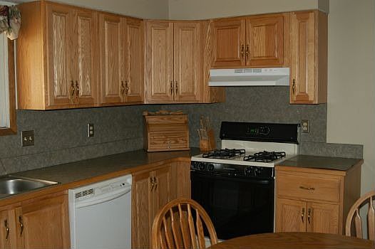 Custom cabinets and tiled floors in kitchen and bathrooms