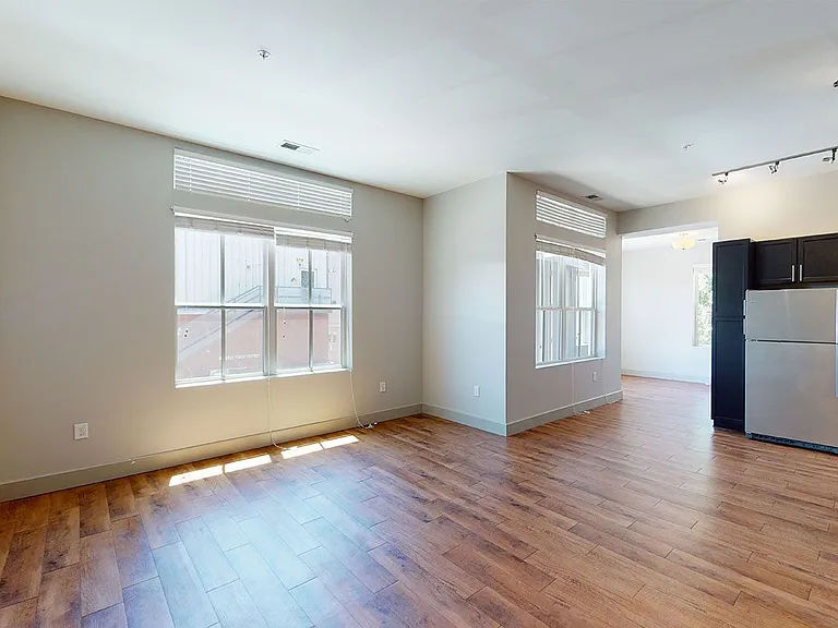 Apartment living room with wood-style flooring.