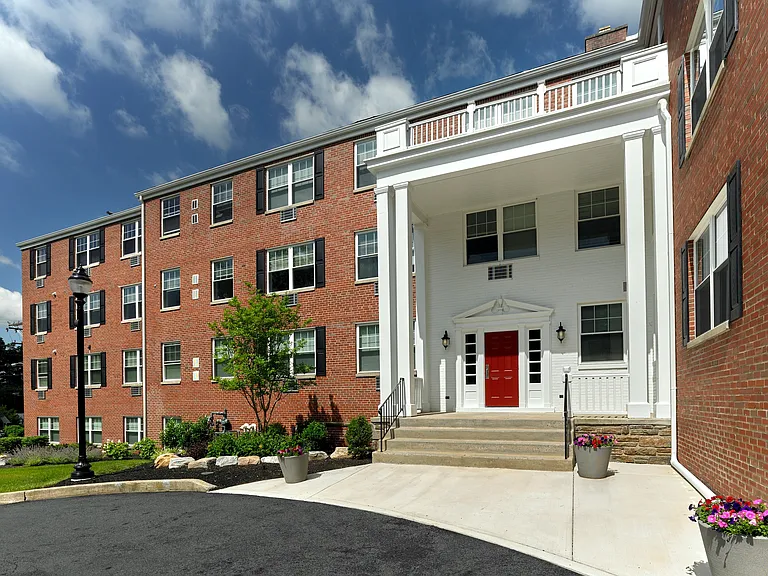 Crestwood Apartments in Wayne, PA _ Classic brick exterior and welcoming red door entry with colonial charm