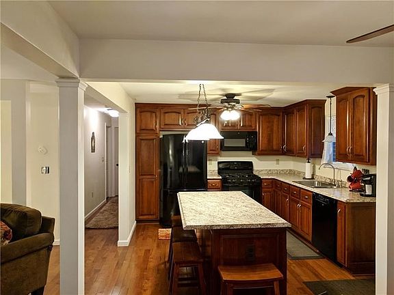 Updated kitchen with custom made Cherry cabinets, large new center island, new light fixtures, new Plymouth brown hickory floori