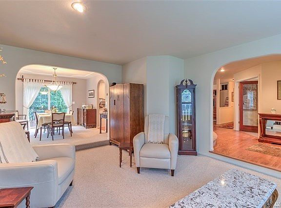 Looking toward the dining area you can see that this formal living is showing off its angular walls.  Because of these angles you have three more generous areas for furniture.  Open up the patio doors off the dining area for that cross breeze to the livin