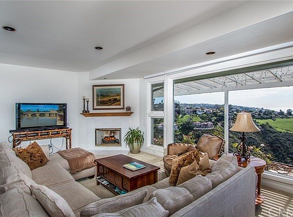 Family room features a gas burning fireplace and smooth ceilings.