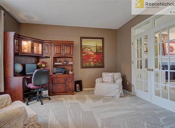 Office off of front door is accented with two sets of french doors.