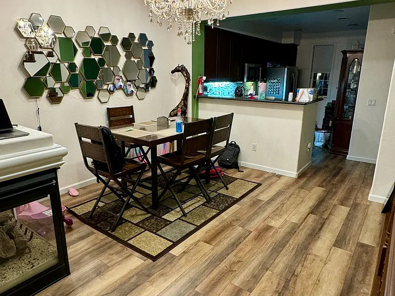 Upgraded dining room with luxury vinyl planks, chandelier and recessed lighting with smart switches