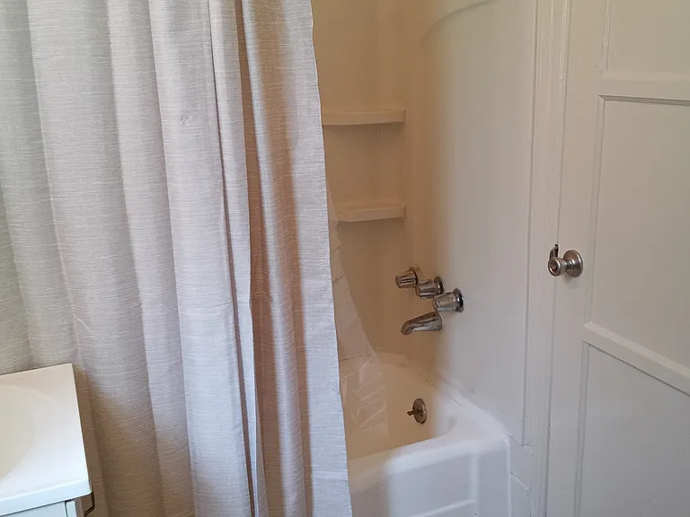 Bath with shower over tub