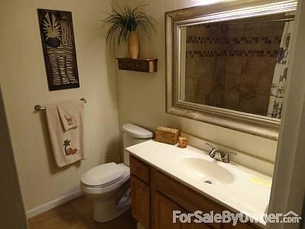 View into hallway bathroom from hall.