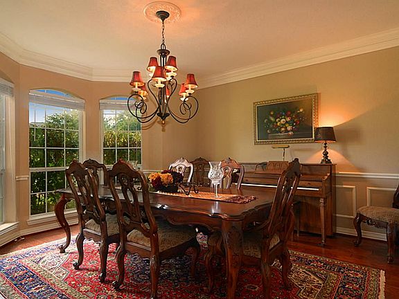 The massive Dining Room was designed to easily handle large gatherings and is finished with hardwood floors, an appetizing chair rail, custom paint, tasteful crown molding and delicious views.  It is even large enough to accommodate a piano