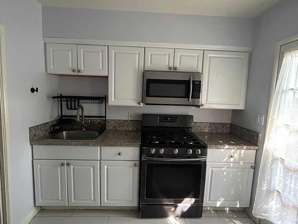 Full kitchen with oven, microwave, refrigerator, granite countertops, and lots of cabinet storage