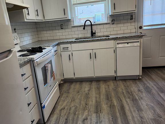 Brand new oven kitchen has small area for table chairs. Backdoor to concrete patio.