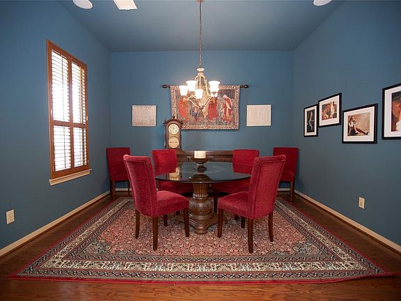 The formal dining is located off the main entry, and looks onto the porch and park beyond.