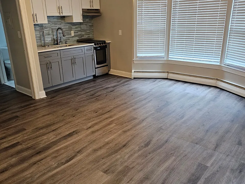View of large room with the kitchen