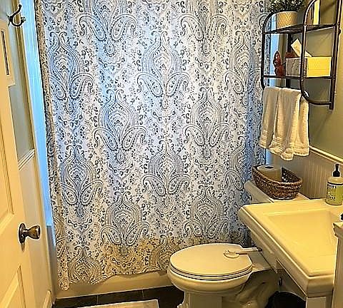 Main hallway bath room with natural stone floors and bathtub