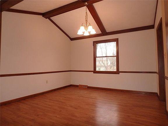 Formal dining room with beamed cathedral ceilings.