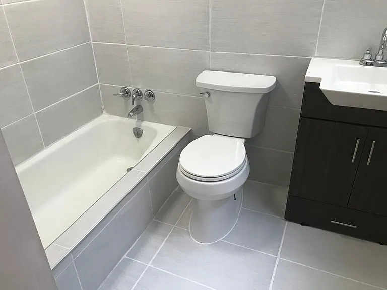1st floor bathroom. Wall to floor tile. We saw this a lot in Vietnam/Asia and love this look. And it's super functional!