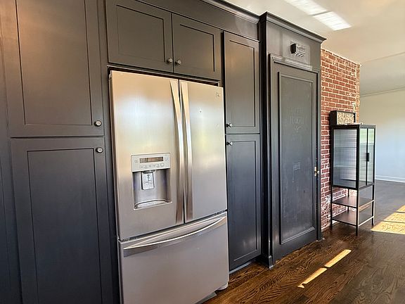 Chef's Galley Kitchen - SS Fridge with Ice Maker - Custom Cabinetry with Pull Out Drawers, Exposed Brick, Hardwood Floors.