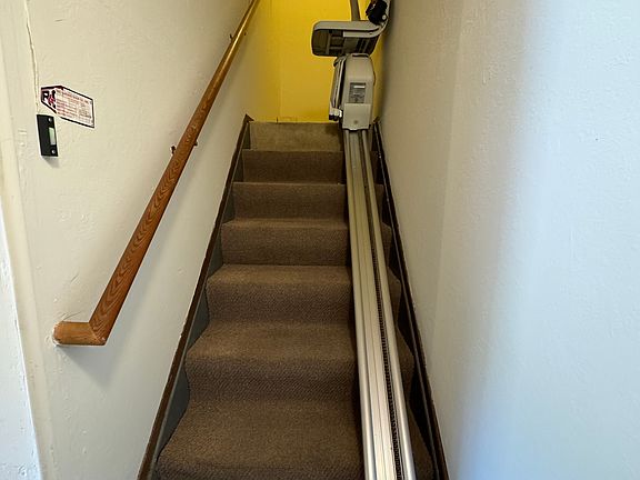 Chair lift from ground level garage up to second floor unit, kitchen entrance.