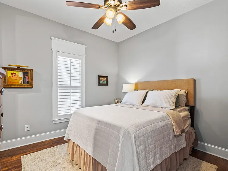 Primary bedroom features high ceilings, rich hardwood floors, and ample natural light!