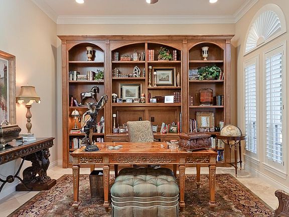  First study located downstairs with custom built-in cabinets.