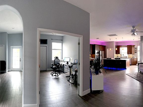 Foyer, hallway leading to 2nd bedroom / guest bath (left), office (middle) and living room to kitchen