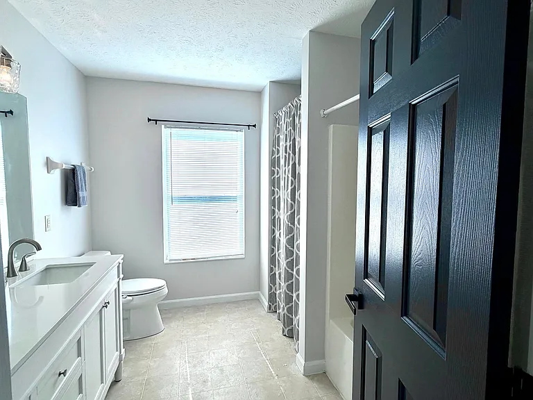 En-suite primary bath with large window for lots of light, generous extra storage area, tub/shower combo. New double bowl vanity with marble top and new modern lighting.