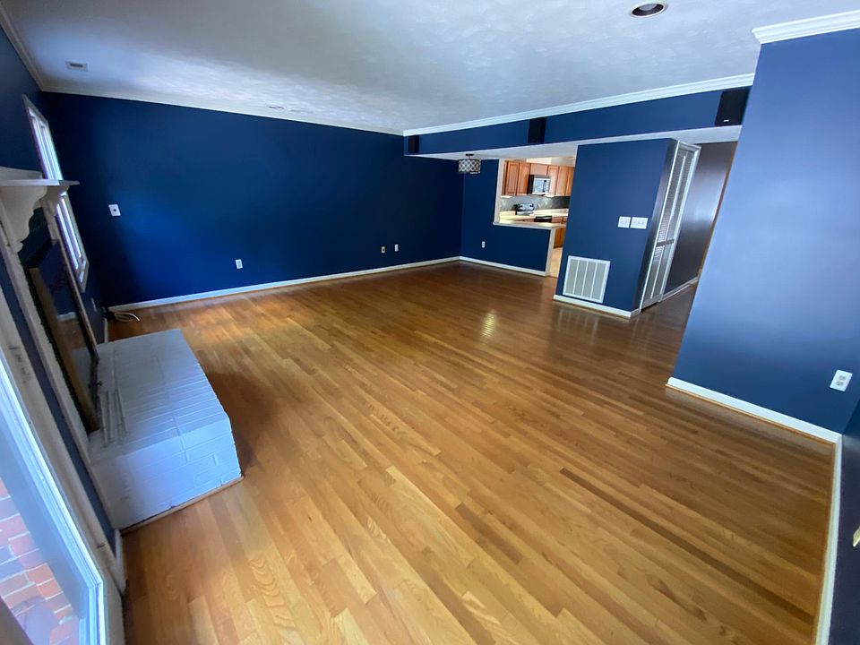 Large den with recessed lighting, fireplace, and oak hardwood floors.