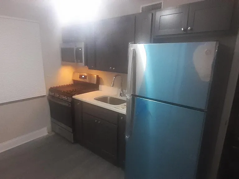 Kitchen with all new appliances ( gas stove, over the range microwave and refrigerator)