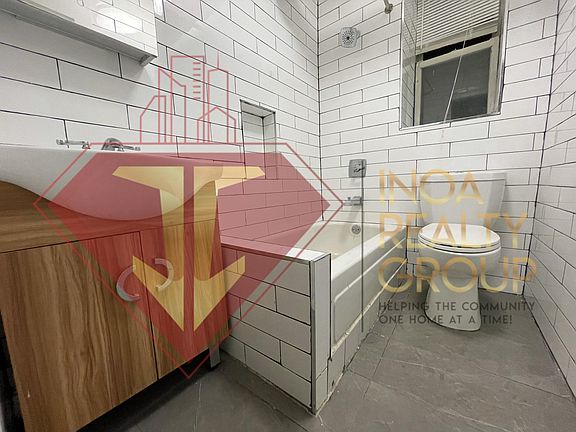 Bathroom with ceramic tile flooring.