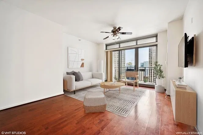 Bright living room with floor-to-ceiling windows and balcony access