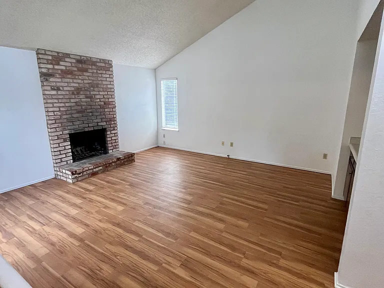 The family/entertaining room features a brick wood fireplace and a wet bar.
