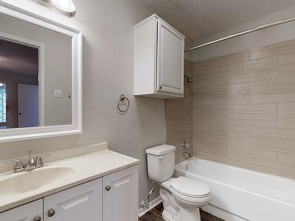 Remodeled bathroom with new vanity and modern shower enclosures in selected units