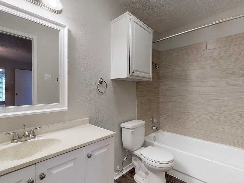 Remodeled bathroom with new vanity and modern shower enclosures in selected units