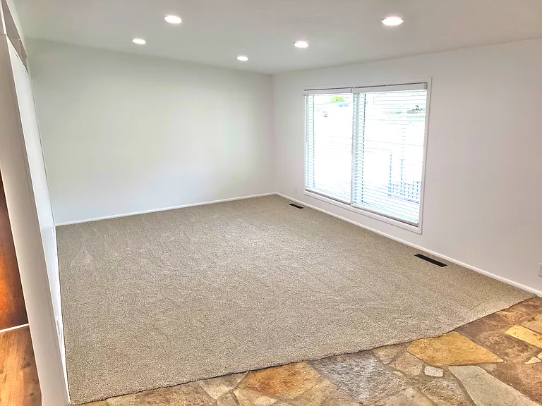 Living room with large windows with blinds