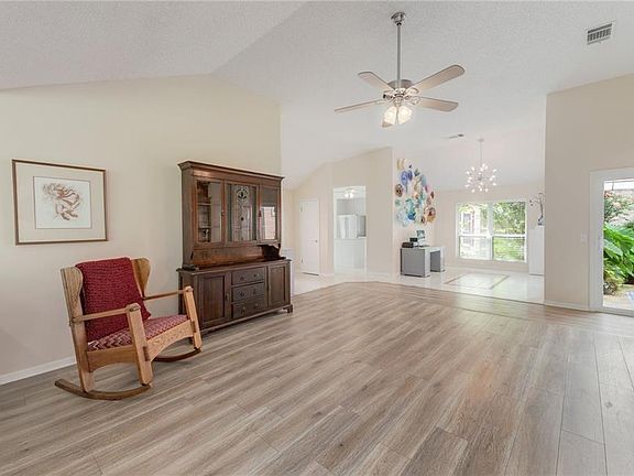 Open floor plan with kitchen, dining and patio connected with the living room.
